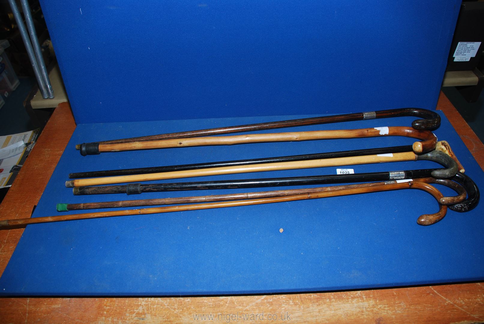 A quantity of walking sticks including three with silver collars including London 1923,