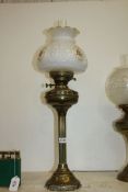 A tall Brass double burner Oil Lamp with chimney and white floral shade, approx. 29" tall overall.