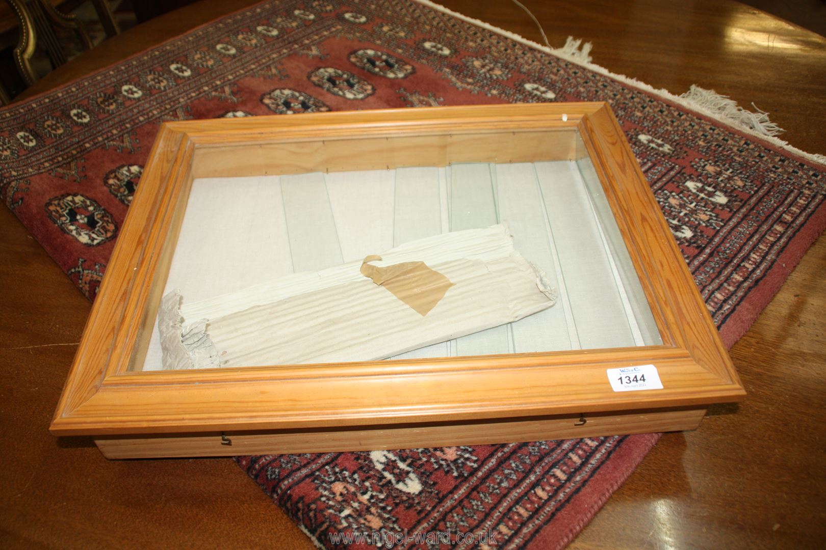 A wall mounted Display Cabinet with glass shelves, 20 1/2" x 16 1/2" x 3" deep.