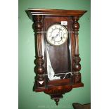 A Victorian wall Clock with Roman numerals. 26 1/2'' high overall x 14'' wide.