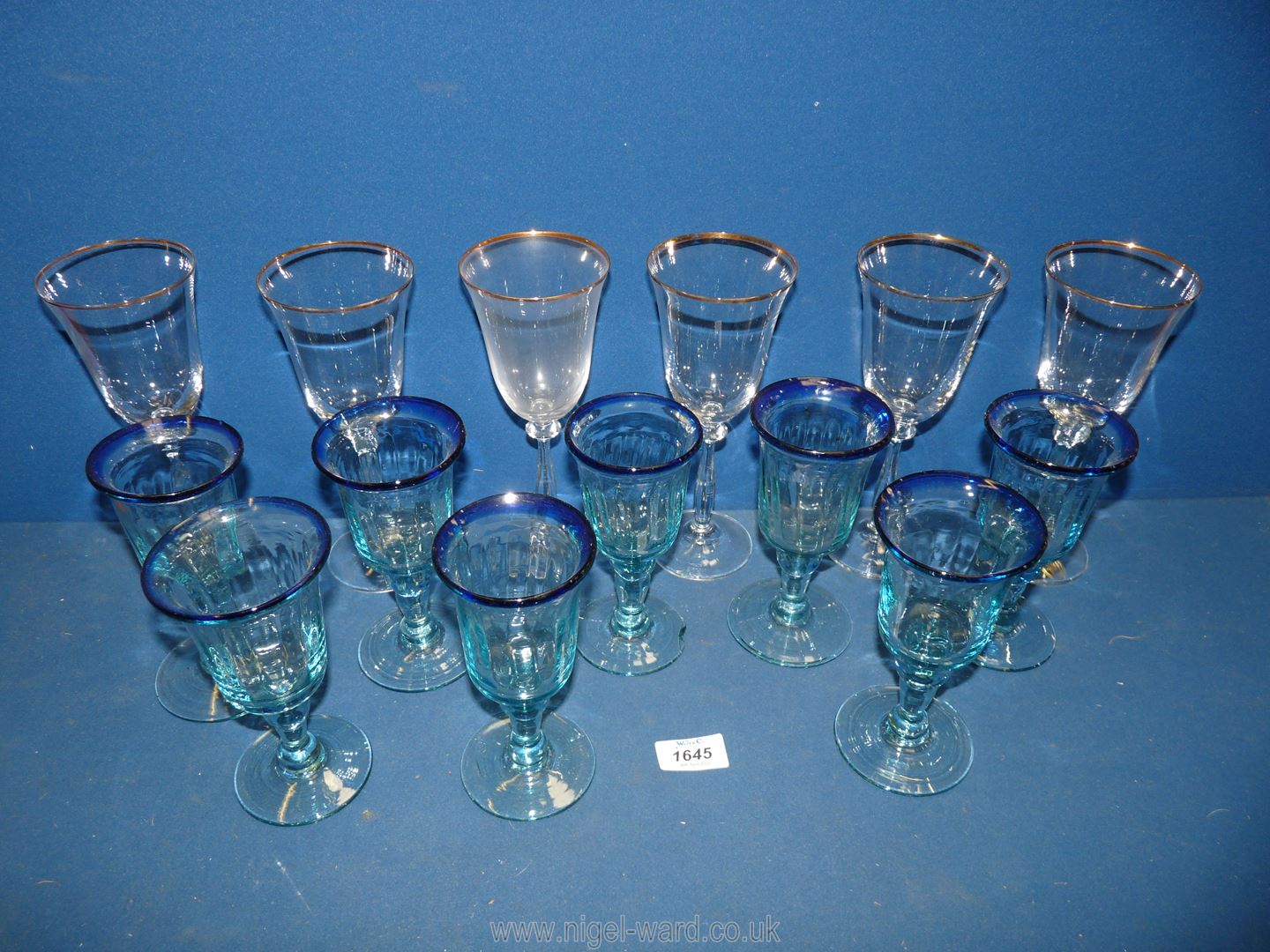 A set of 6 Italian wine glasses with gilt rims and a set of 8 blue wine glasses.