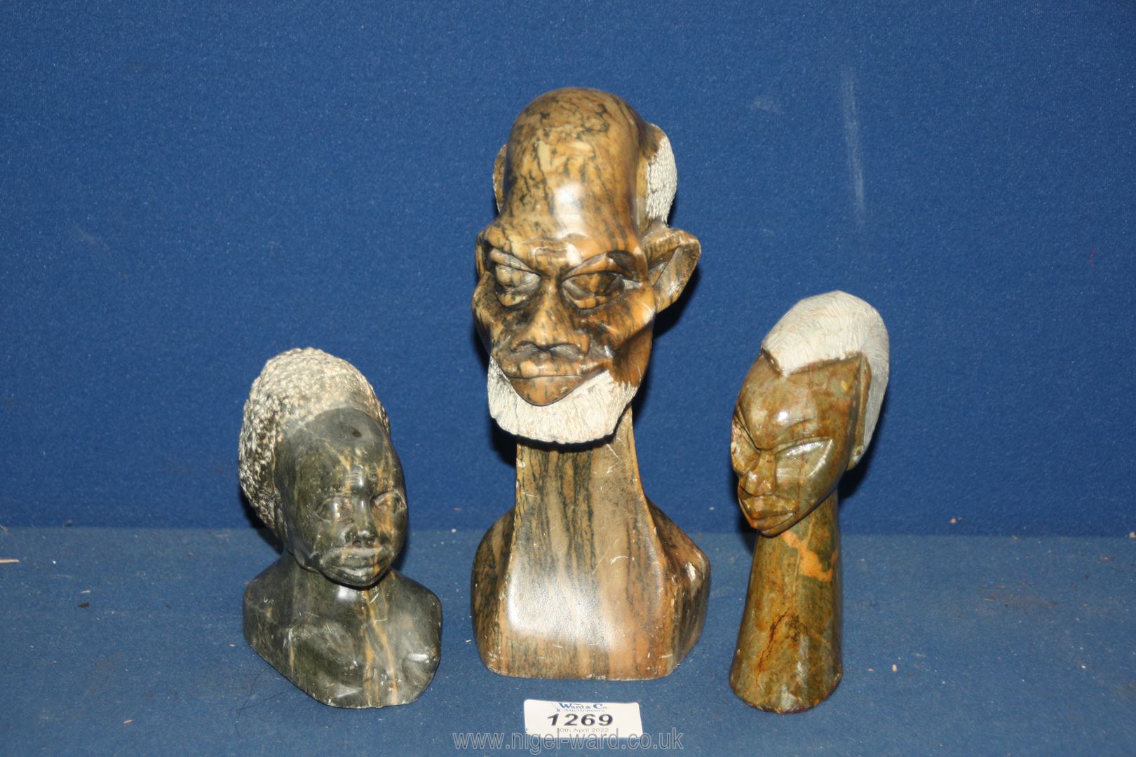 Three carved stone Ethnic heads, (some chips), 8'', 5 1/4'' and 4'' tall.
