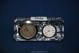 An Edinburgh crystal clock having a £5 Anno Domini 1999-2000 coin inserted 4 3/4" x 2 1/2" tall.