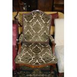 An elegant Walnut/Mahogany framed broad seated open armed Armchair having scroll terminating arms