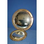 A convex brass porthole style Mirror, 14'' diameter and a similar convex porthole style mirror,
