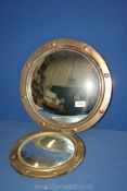 A convex brass porthole style Mirror, 14'' diameter and a similar convex porthole style mirror,