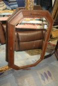 An octagonal bevel edged wall Mirror in light oak frame with raised detail, 32'' x 21''.