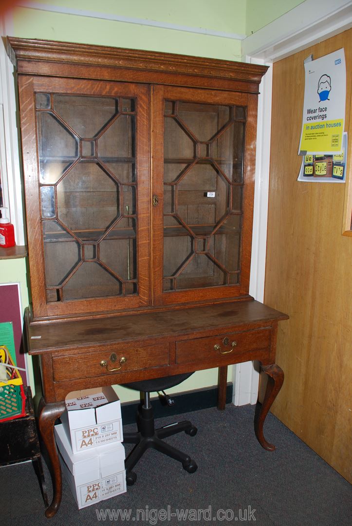 An unusual Oak Writing Table/Bookcase the table having two frieze drawers and standing on stylish