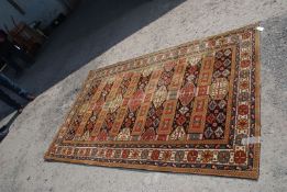 A multi-coloured bordered and geometric patterned Rug,