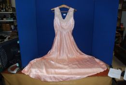 A 1930's salmon pink satin and lace nightdress (small size).