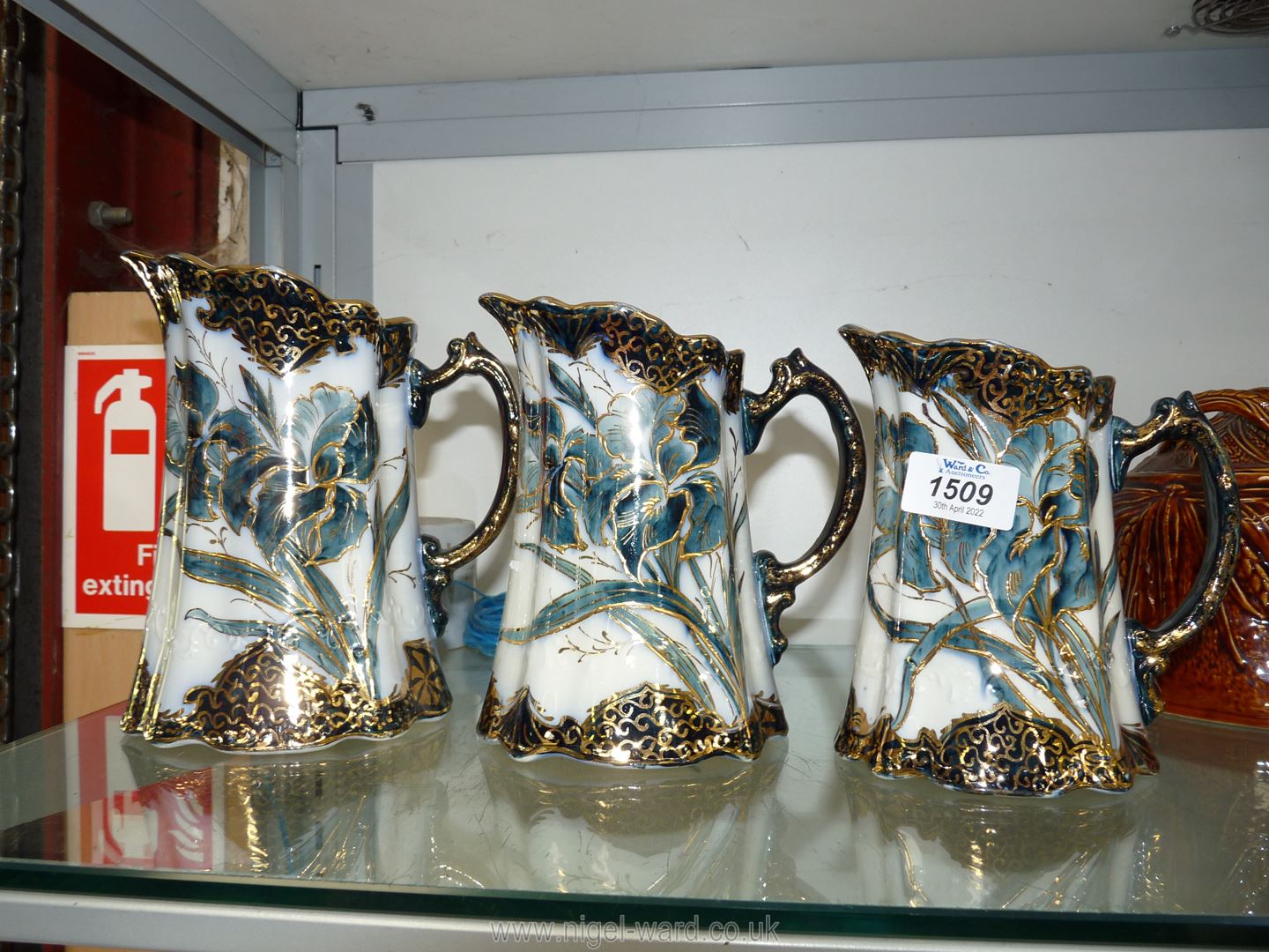 A graduated set of three Jugs in blue and gilt with iris design.