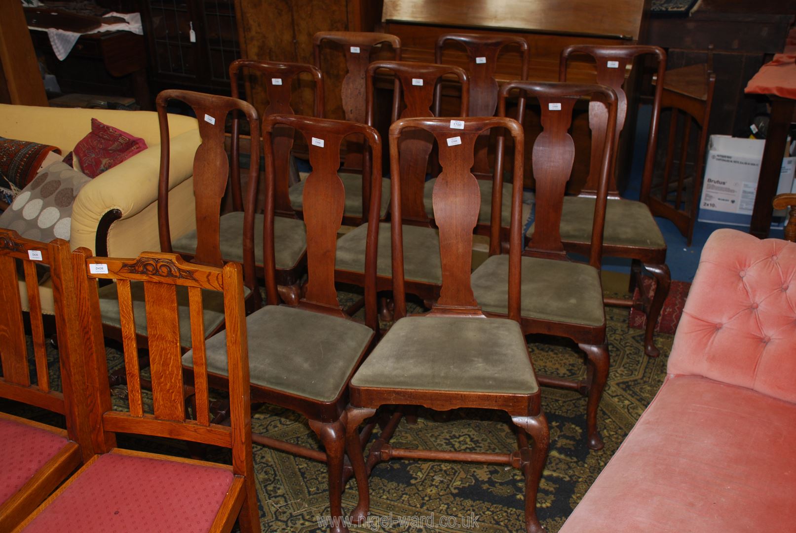 A set of nine elegant Walnut framed Dining Chairs of traditional Queen Anne design having cabriole