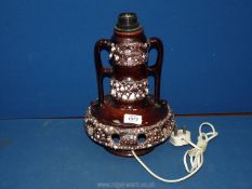 A German pottery two handled Lamp in brown with holes to the base to let the light shone through,
