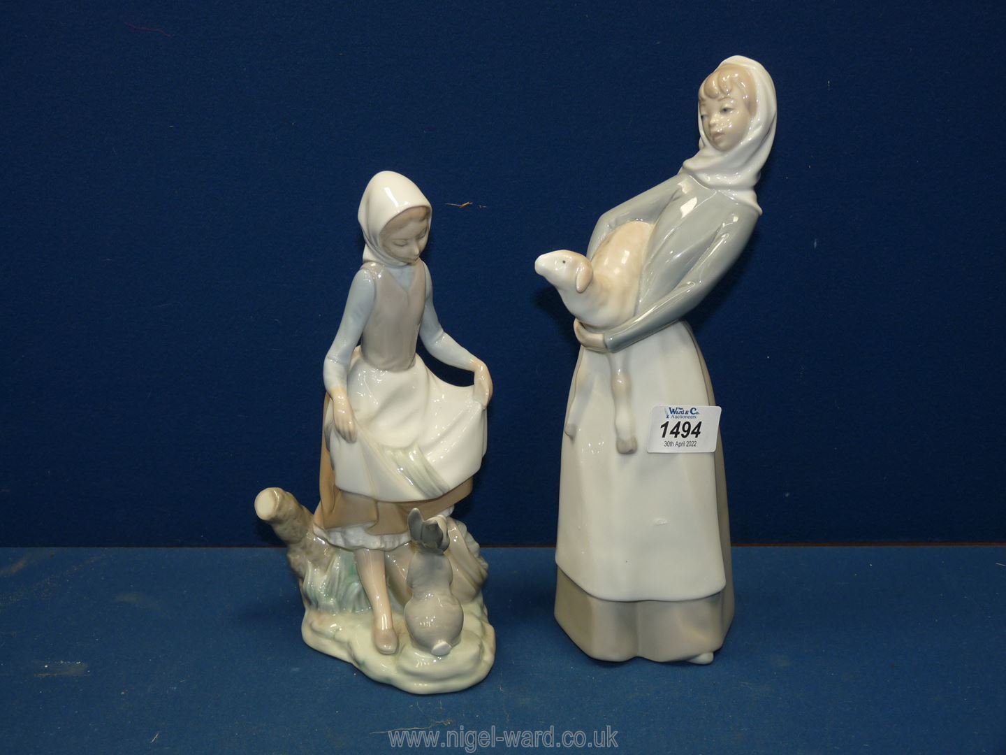 Two Lladro figures of girls with rabbit and lamb, 9 1/4'' and 11'' tall respectively.