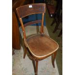 A Bentwood framed cafe type chair having a fan pattern in relief to the seat.