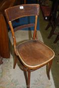 A Bentwood framed cafe type chair having a fan pattern in relief to the seat.