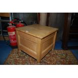 A light Pine box Commode standing on turned legs, 19 3/4" deep x 19" wide x 17 3/8" high.