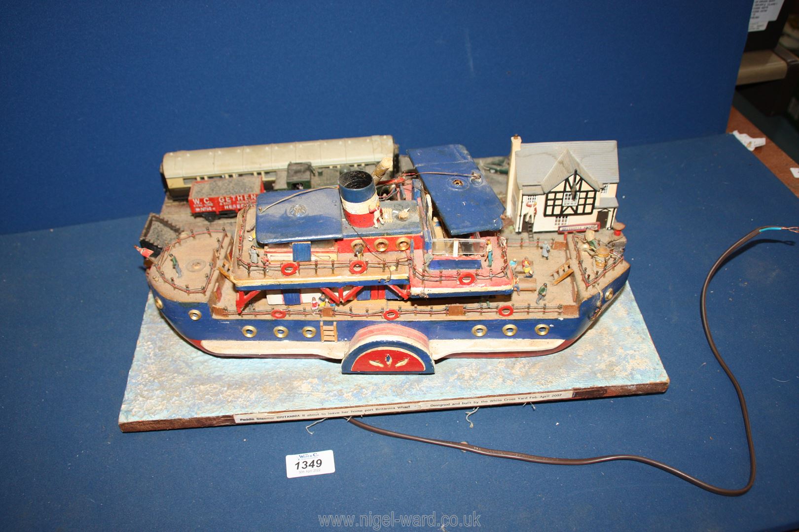 A hand built model of a Paddle boat steamer 'Britannia' and a train station wired for electric, a/f.