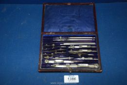 A brown/maroon leather presentation cased set of high quality Nickel drawing Instruments including