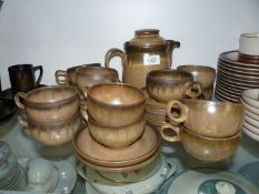 A Denby Romany Teaset including a teapot, twelve cups and saucers.
