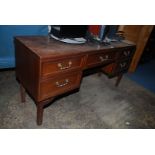 A "G-Plan" teak finished Dressing table/Desk having five drawers with brass finished drop handles