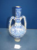 An old near eastern blue and white two handled pottery jar 13 3/4" tall, a/f.