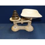 A pair of cast iron kitchen Scales with pan, 13'' wide and set of brass weights.