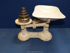 A pair of cast iron kitchen Scales with pan, 13'' wide and set of brass weights.