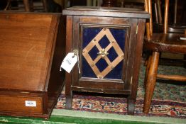 A small Cabinet with blue glass panel to door having feature copper diamond decoration,