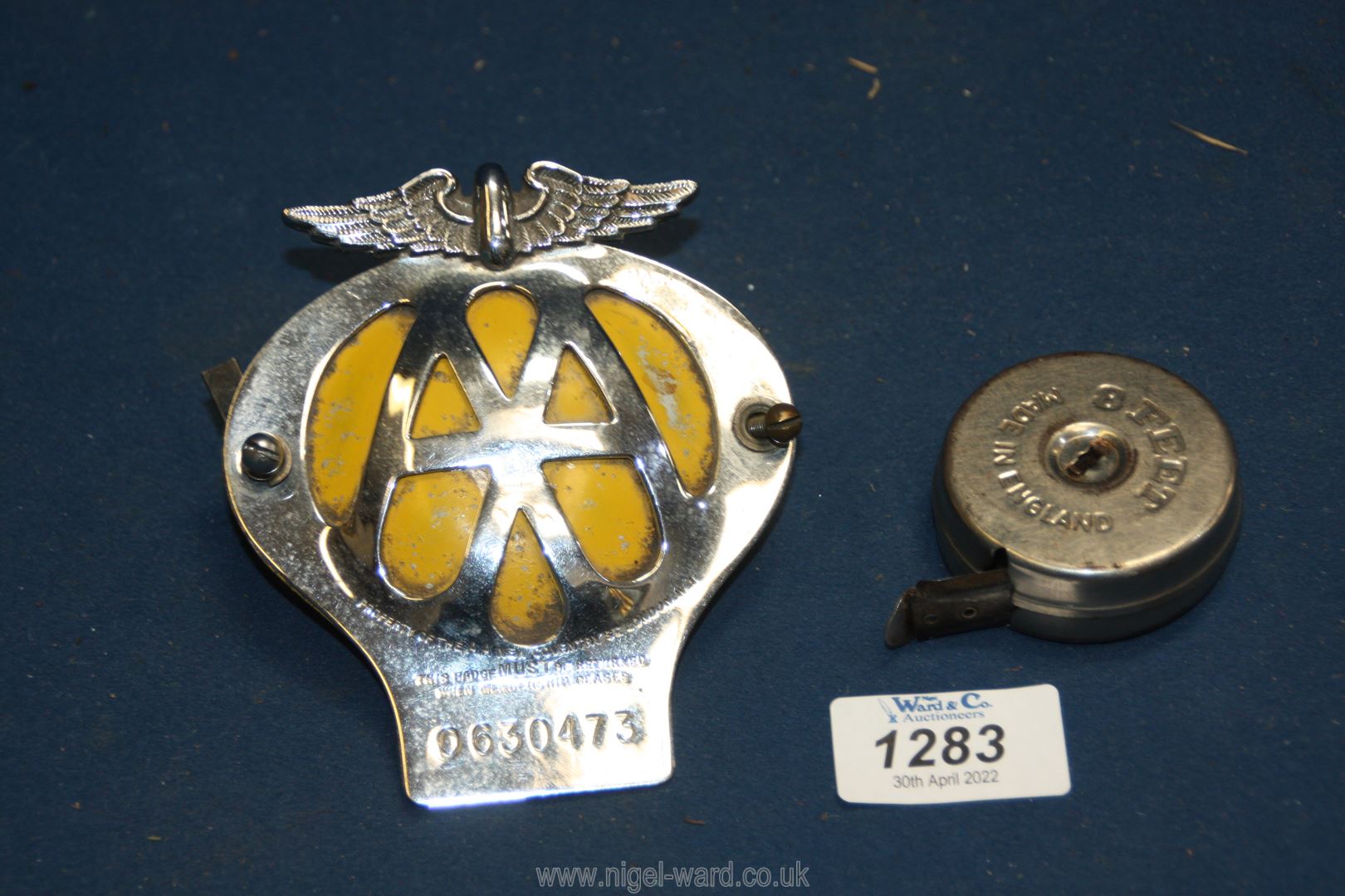 An A.A. Car badge, serial no .0630473 and an old A1 8ft metal tape measure.