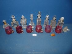 A small quantity of cut glass scent bottles and six cranberry glass cups.