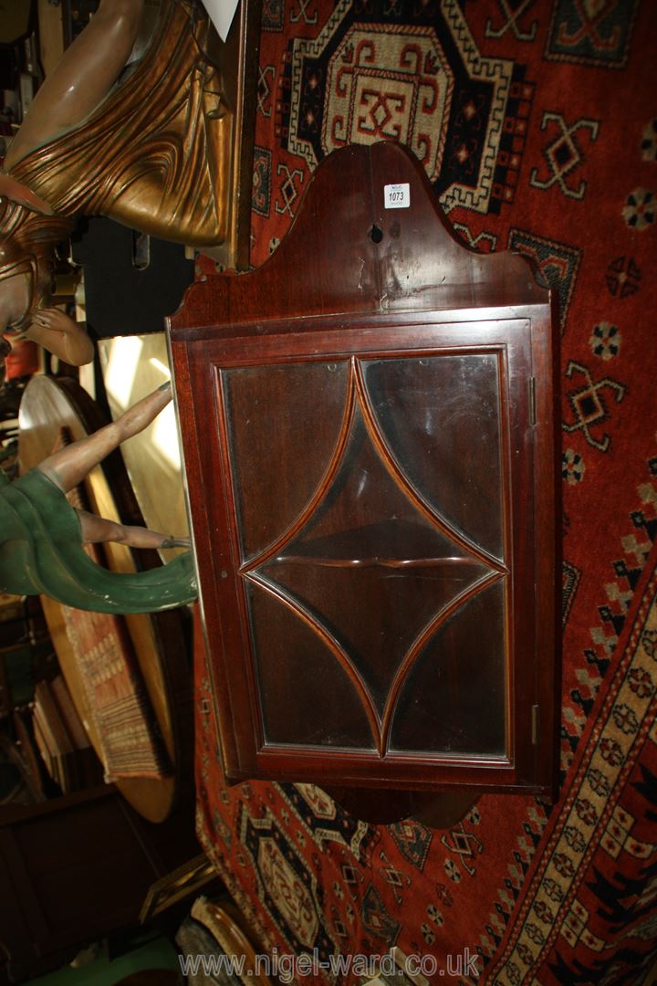 A glazed Mahogany wall hanging corner cabinet, 29 1/2'' high overall.