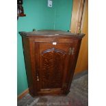 An Oak wall hanging Corner Cupboard, the shaped,