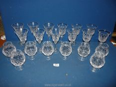 Eight cut glass Royal Doulton brandy balloons and twelves wine glasses (one with chip to rim).