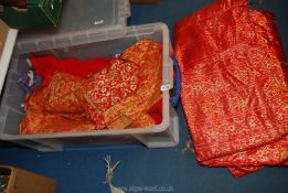 A quantity of red and orange textiles including satin damask brocade,