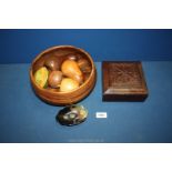 A large treen fruit bowl 10" diameter containing oak, mahogany, holly wood fruits etc.