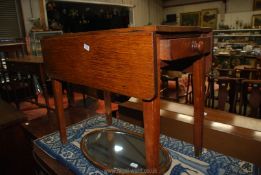 An Oak Pembroke Table standing on tapering square legs and having a full length drawer to one end