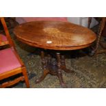 An oval Walnut occasional Table having lightwood stringing Tunbridge style details to the top,