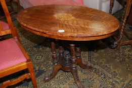 An oval Walnut occasional Table having lightwood stringing Tunbridge style details to the top,