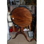A Mahogany snap top occasional Table standing on a turned pillar with three splay feet,