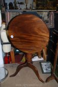 A Mahogany snap top occasional Table standing on a turned pillar with three splay feet,