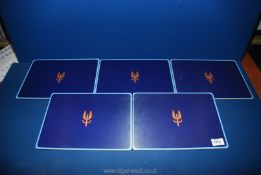 Five table mats with the insignia of the SAS to the centre on a blue ground.