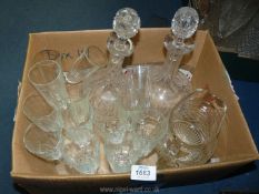 A quantity of wine glasses, two cut glass decanters and water jug.