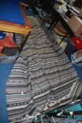 A fringed grey striped woven rug, 76'' x 114''.