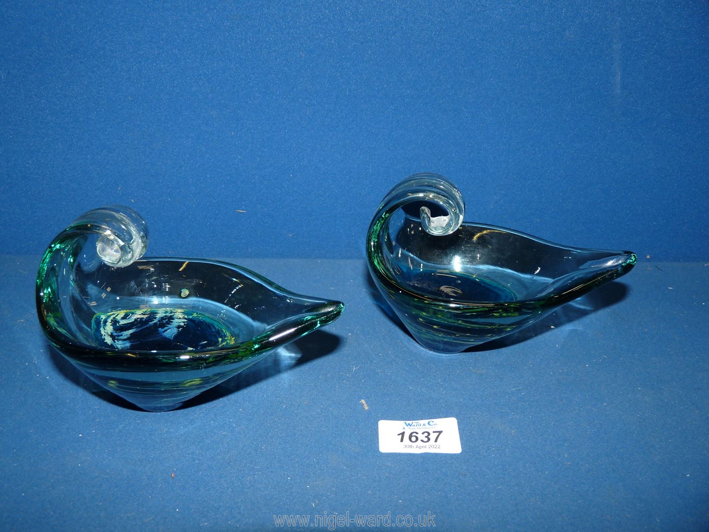 A pair of Mdina boat shape bowls with curved handles in shades of blue each 5 1/2" long.