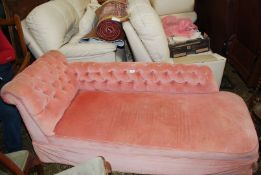 A button back pale pink Draylon upholstered Day Bed standing on painted turned legs,