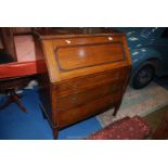 A 1930's/40's Oak Bureau, the fall front revealing an interior with pigeon holes,