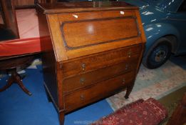 A 1930's/40's Oak Bureau, the fall front revealing an interior with pigeon holes,