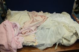 A quantity of vintage children's clothing including petticoats, dresses, bath cloaks etc,