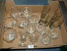 A box of mixed fruit bowls, some etched and five smoky glass tumblers.